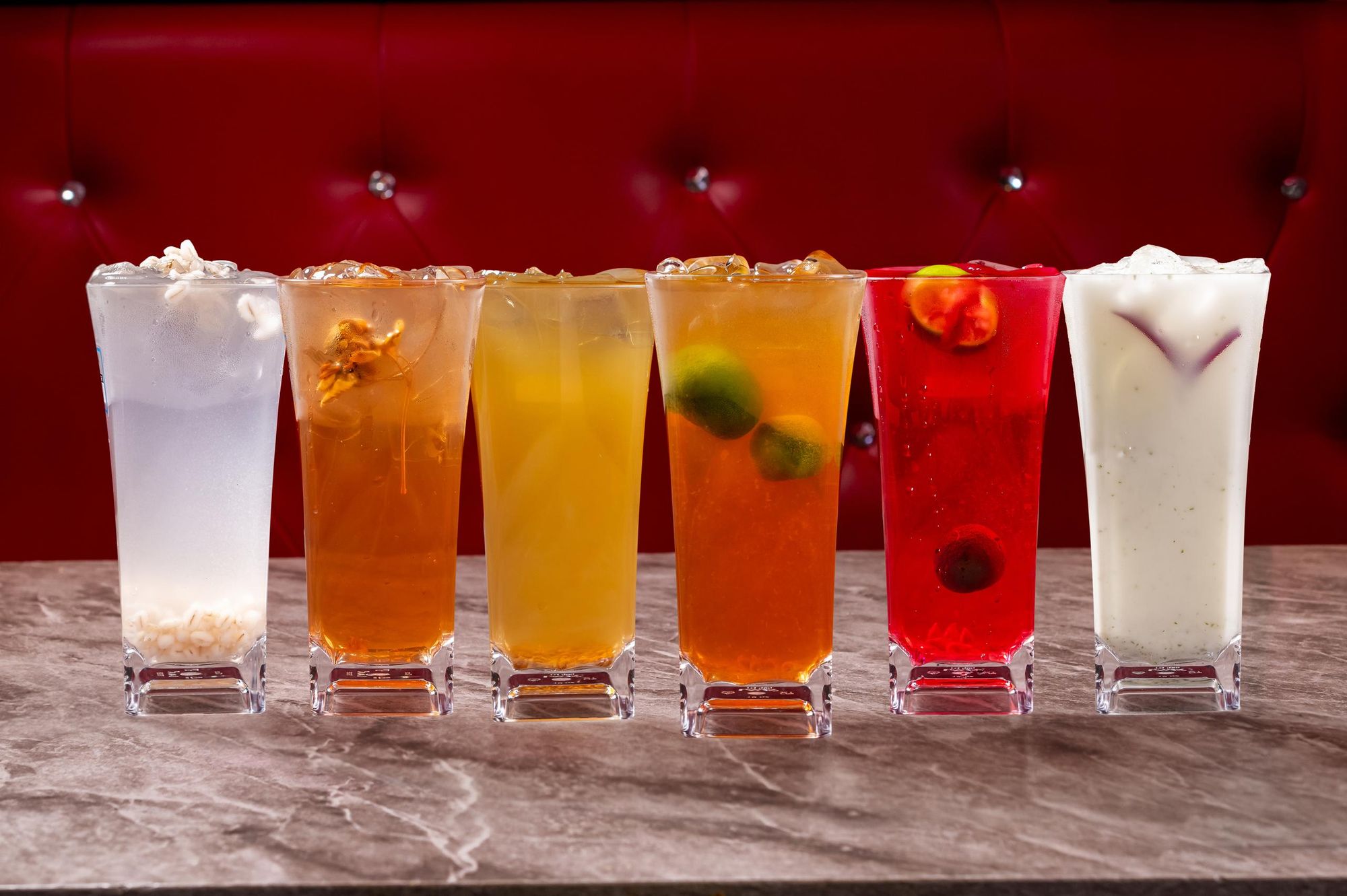 House drinks lined up against the red booth