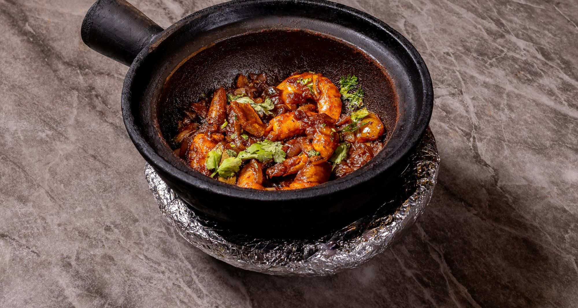 Prawn masala in a clay pot