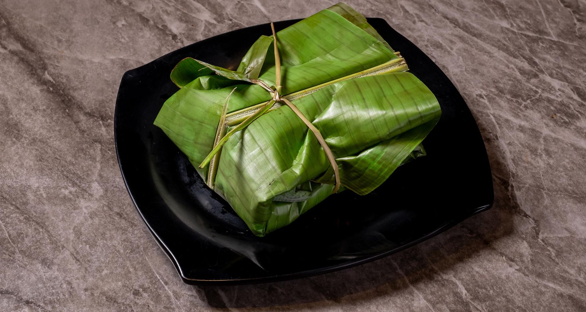 Kizhi parotta, tied by hand in banana leaf